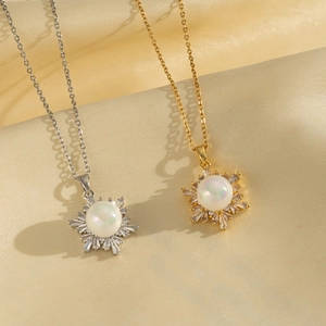 Sparkling snowflake necklaces in gold and silver finish with pearls on silk fabric
