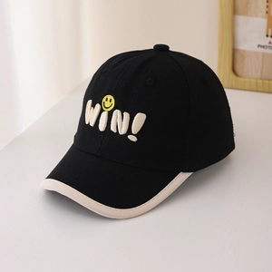 Close-up of black baseball cap with WIN letter embroidery and yellow smiley face detail