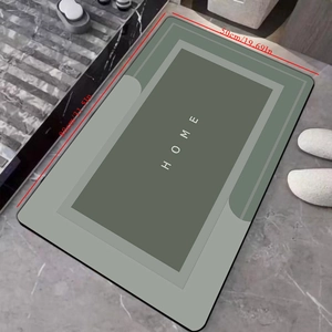 Detail view of a 50x80cm absorbent diatom mud bath mat with HOME text and non-slip backing