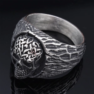 Detailed close-up of a vintage skull ring featuring Celtic knots in antique silver finish