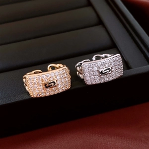 Macro shot of gold and silver rectangle zircon rings displayed on premium black leather