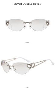 Detail of silver rimless Y2K sunglasses featuring double heart metal decorative hinges