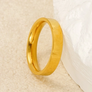 Minimalist gold titanium steel band ring with polished finish shown on white texture