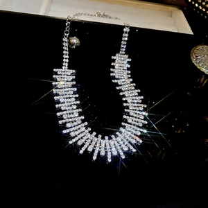 Macro shot of silver crystal choker with layered rhinestones and adjustable bell chain