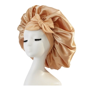 Champagne gold satin hair bonnet with wide band and bow tie for hair protection