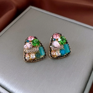 Detailed view of vintage triangle stud earrings with colorful crystals and black gold beads