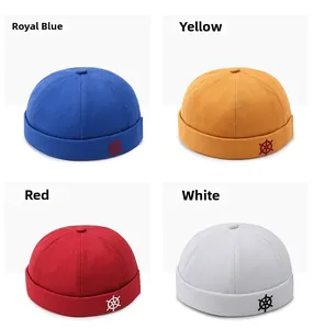 Detail view of cotton docker hats in royal blue, yellow, red, and white with helm embroidery