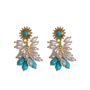Vintage style drop earrings with gold metal base, blue stones and white teardrop pearls