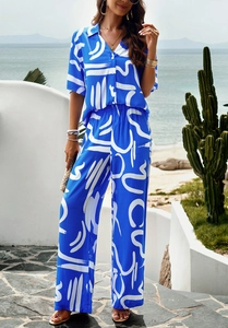 Close-up of blue V-neck short sleeve shirt and wide-leg pants with abstract prints