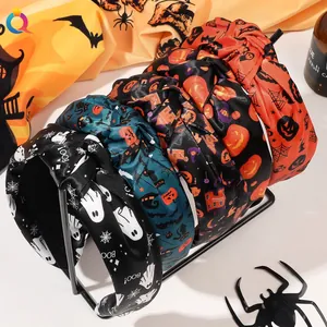 Detail showing various Halloween knot headbands with pumpkin and ghost prints on a display stand