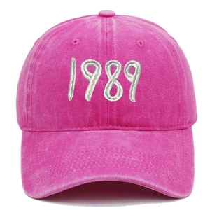 Close-up of vintage pink washed cotton baseball cap with white 1989 embroidery