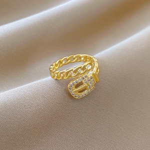 Adjustable gold chain belt ring with pave zircons on elegant silk background