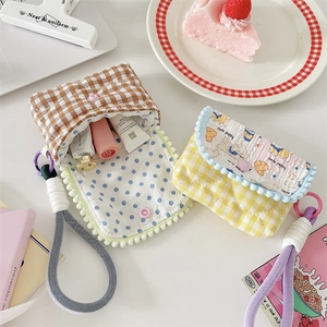 Detailed view of quilted cotton camera pouches with cute puppy and dot patterns