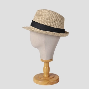 Close-up of fine woven straw fedora hat featuring a classic black grosgrain ribbon band