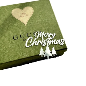 Gucci green embossed Christmas gift box with white Merry Christmas text and mirror trees