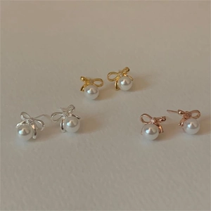 Elegant bow knot pearl earrings in gold, silver, and rose gold finishes set