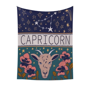 Detail of Capricorn zodiac tapestry featuring star maps and goat head floral patterns