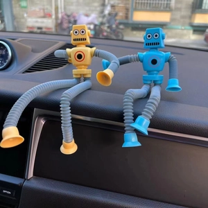 Blue and yellow robot toys with suction cups on dashboard showing flexible limbs