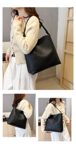 Detail of large black woven shoulder bag showing spacious design and faux leather texture