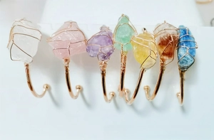 Detail view of seven natural crystal stone open bangles with gold wire wrapping