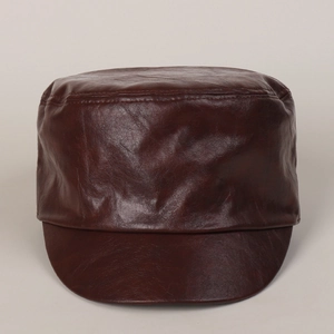 Close-up of soft dark brown PU leather texture and stitching on a vintage cadet cap