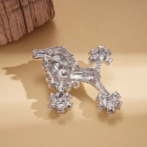 Detailed back view of poodle brooch with silver metal base and secure pin closure