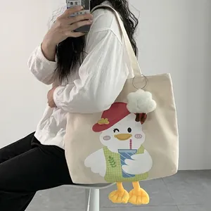 Cute off-white canvas duck tote bag with plush charm and 3D feet for women and students
