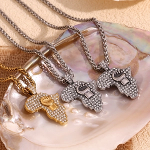 Detail of African map pendants with fist design and crystals on cuban chains