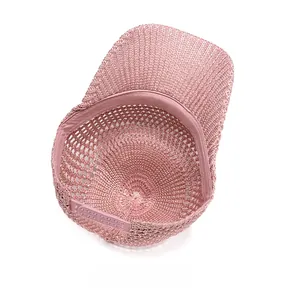 Detail of pink mesh baseball cap showing breathable weave and adjustable plastic strap