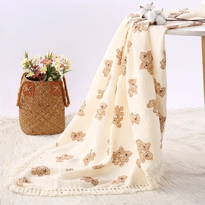 Soft cream cotton muslin baby blanket with brown bear prints and tassel edges for strollers