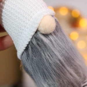 Detailed macro view of Christmas gnome ornament with white knit hat and grey beard