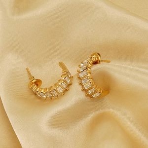 Elegant gold-plated U-shaped earrings with rectangular zircons on silk background