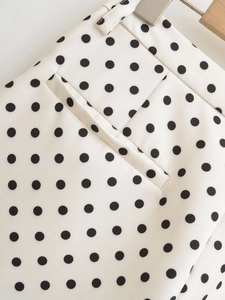 Detail view of polka dot shorts showing waist stitching and side pocket construction