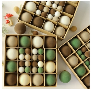 Macro detail of flocked velvet Christmas ornaments in earthy tones with cardboard packaging