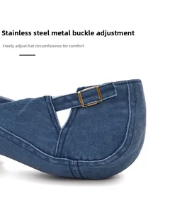 Detail of adjustable stainless steel buckle on navy denim newsboy cap for size adjustment