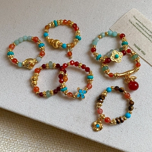 Ethnic gold plated elastic rings with tiger eye stone, red agate and jade beads