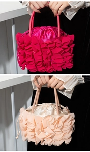 Detail of ruffled satin evening bag featuring drawstring closure and tiered layers