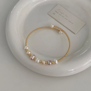 Detail of multi-color freshwater pearl bracelet with gold wire wrapped adjustable band