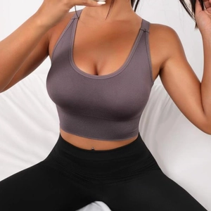 Deep purple-grey seamless sports bra with wide ribbed band worn by a model