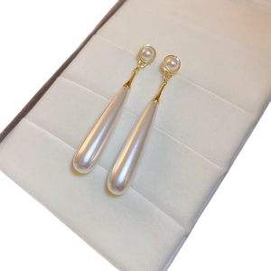 Elegant gold drop earrings with white round and teardrop pearls in a velvet gift box