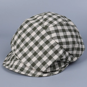 Detailed view of dark green gingham linen newsboy cap with classic checked fabric texture