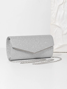 Close-up of sparkling silver sequin fabric and sleek metallic chain strap on an evening bag