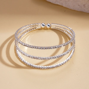 Macro shot of silver triple-layer spiral bangle encrusted with sparkling cubic zirconia