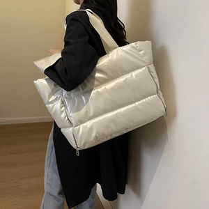 Quilted waterproof fitness bag in ivory white featuring large capacity and puffy nylon texture