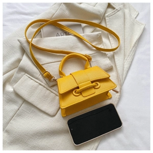 Mini yellow crossbody bag with litchi texture shown next to a smartphone for size reference