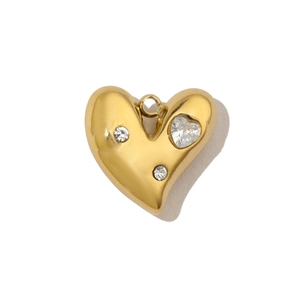 Detailed view of a gold heart-shaped pendant with three inlaid clear zircon stones