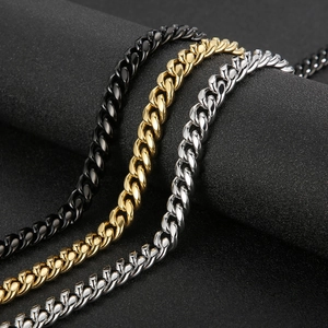 Close-up of stainless steel Cuban link chains in black, gold, and silver finishes