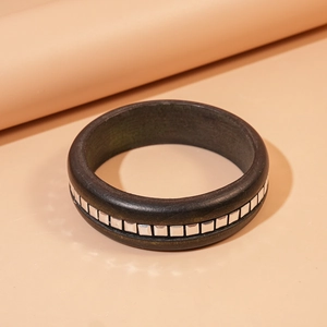 Retro square wood bangle with silver metal accents on a minimalist beige background