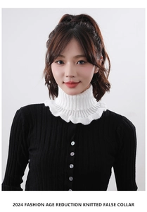 Close-up of white knitted turtleneck false collar with elegant ruffled edge details