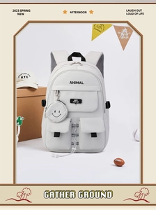 Detail of light grey school backpack featuring multiple zip pockets and a round coin purse